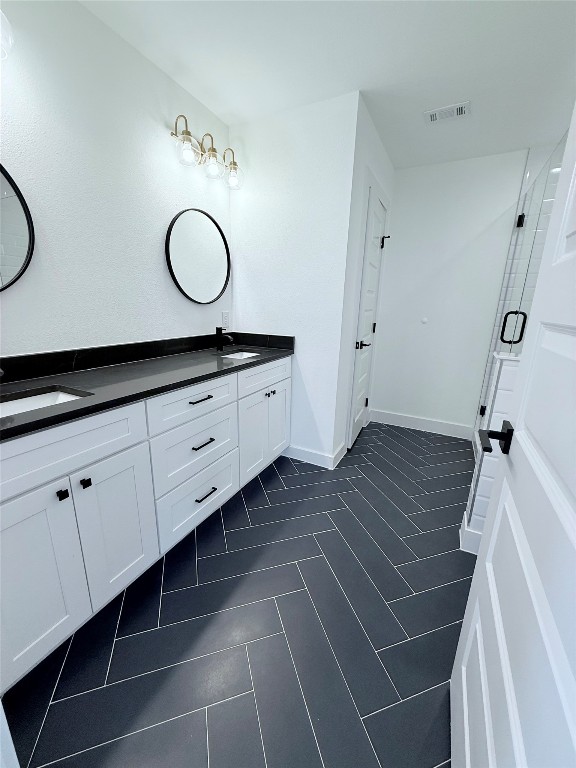 1417 Kramer Lane, Unit 20 Austin, TX 78758 - Photo 8 of 14 Full bathroom featuring double vanity and a stall shower