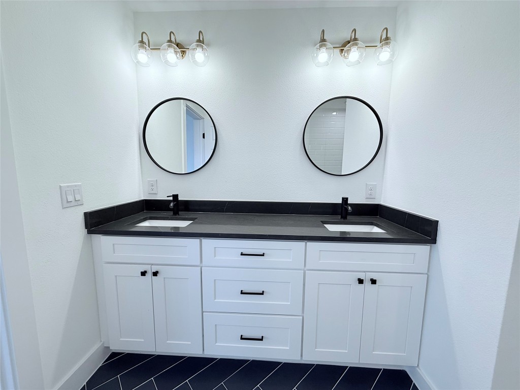 1417 Kramer Lane, Unit 20 Austin, TX 78758 - Photo 9 of 14 Full bathroom with double vanity and baseboards