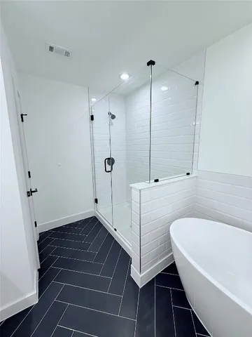 a bathroom with a bathtub and a shower