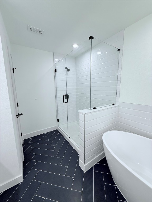 1417 Kramer Lane, Unit 20 Austin, TX 78758 - Photo 10 of 14 Bathroom with a shower stall and a freestanding tub