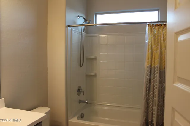 a bathroom with a shower and a toilet