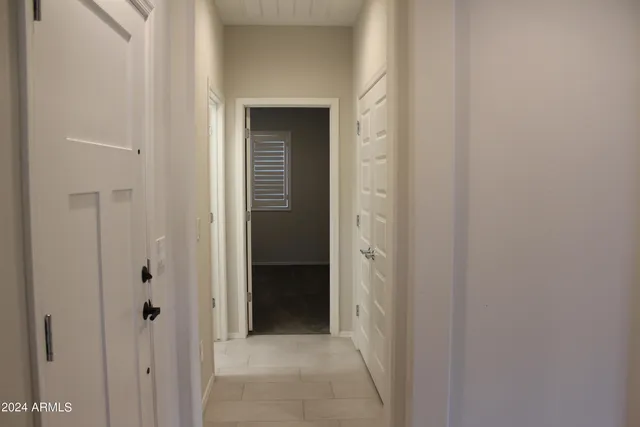 a view of a hallway with a wooden door