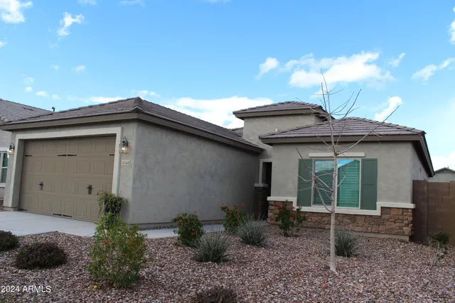 a view of a house with a small yard and plants