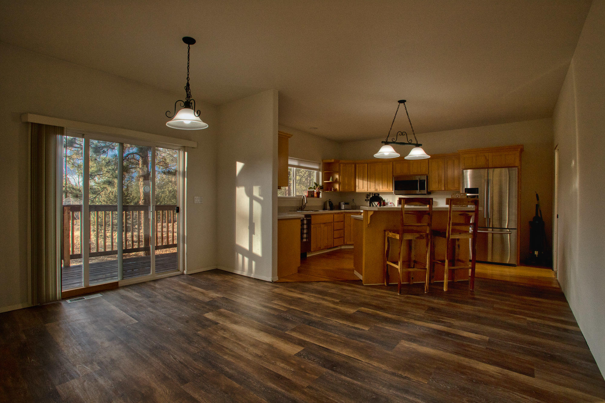 19490 Calico Road Bend, OR 97702 - Photo 9 of 67 a view of a kitchen with furniture and wooden floor