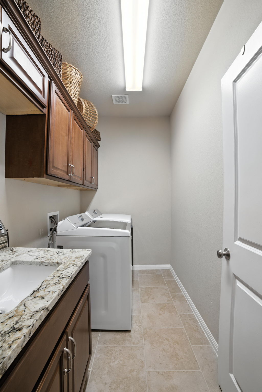 107 Tylee Circle Bastrop, TX 78602 - Photo 17 of 40 a utility room with cabinets washer and dryer