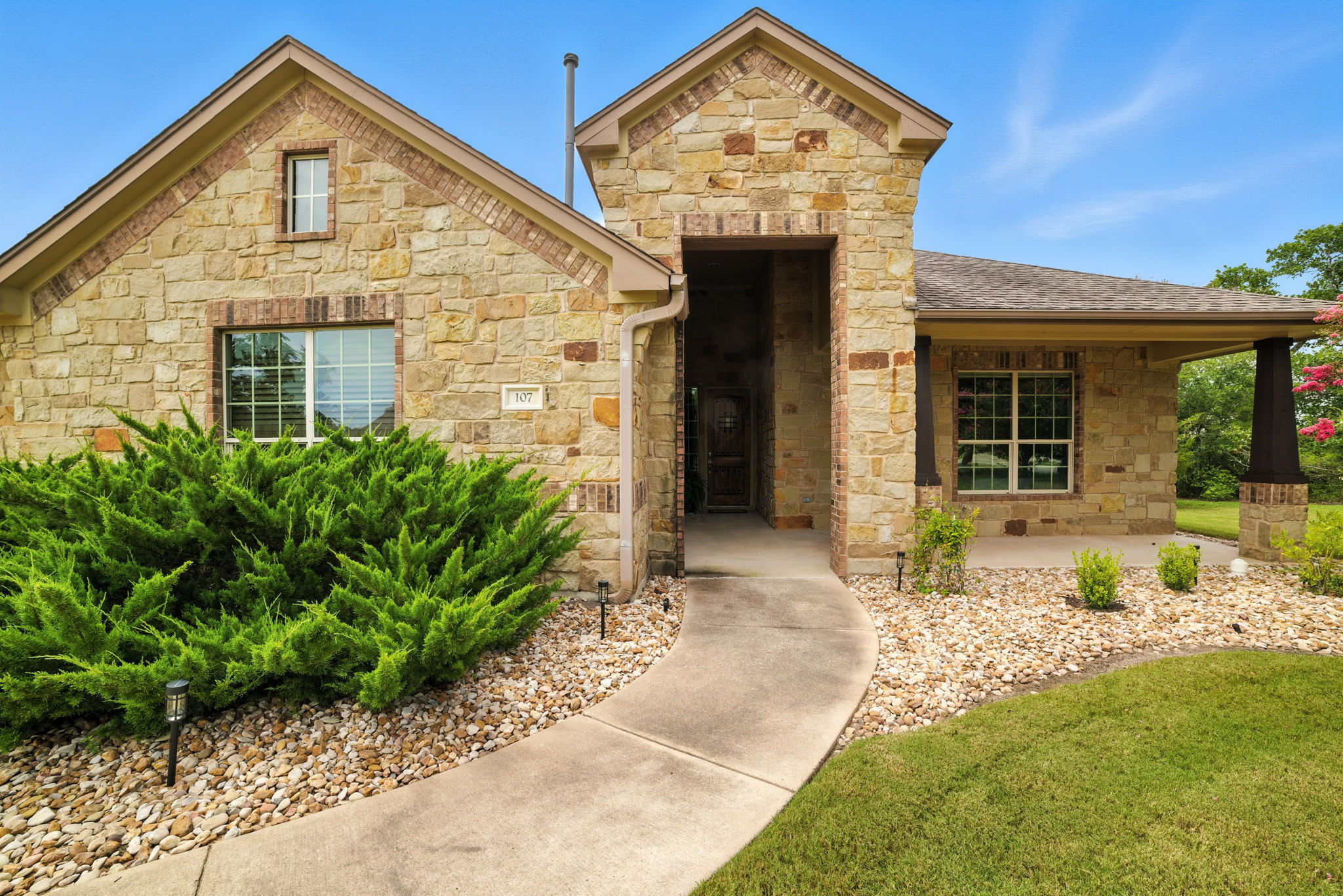 107 Tylee Circle Bastrop, TX 78602 - Photo 2 of 40 a front view of a house with garden