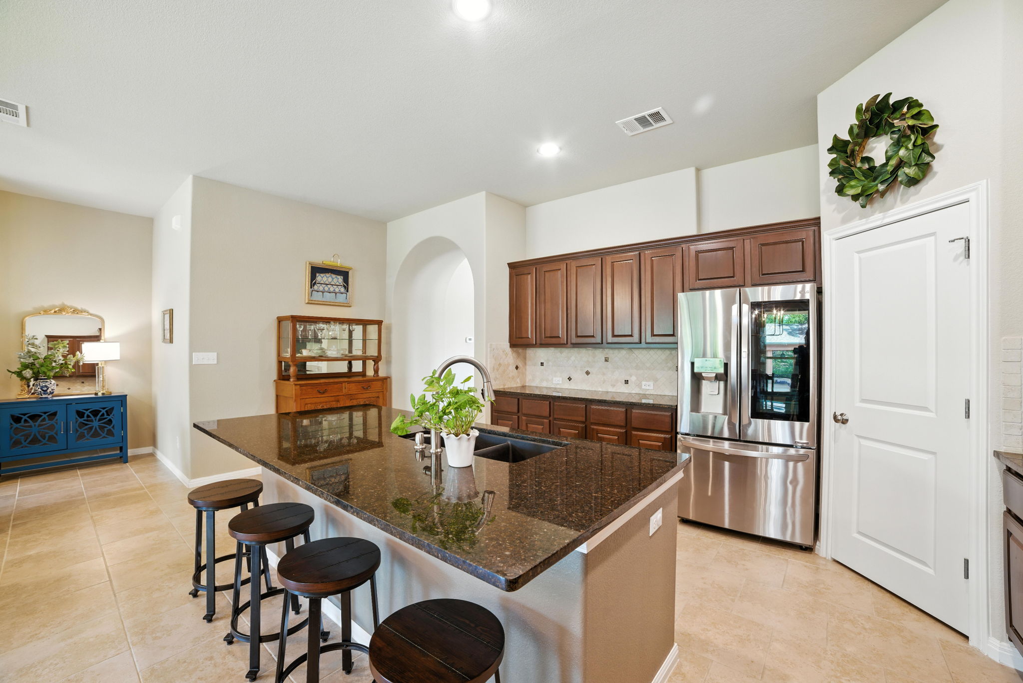 107 Tylee Circle Bastrop, TX 78602 - Photo 21 of 40 a kitchen with granite countertop stainless steel appliances a sink a counter top space and living room view