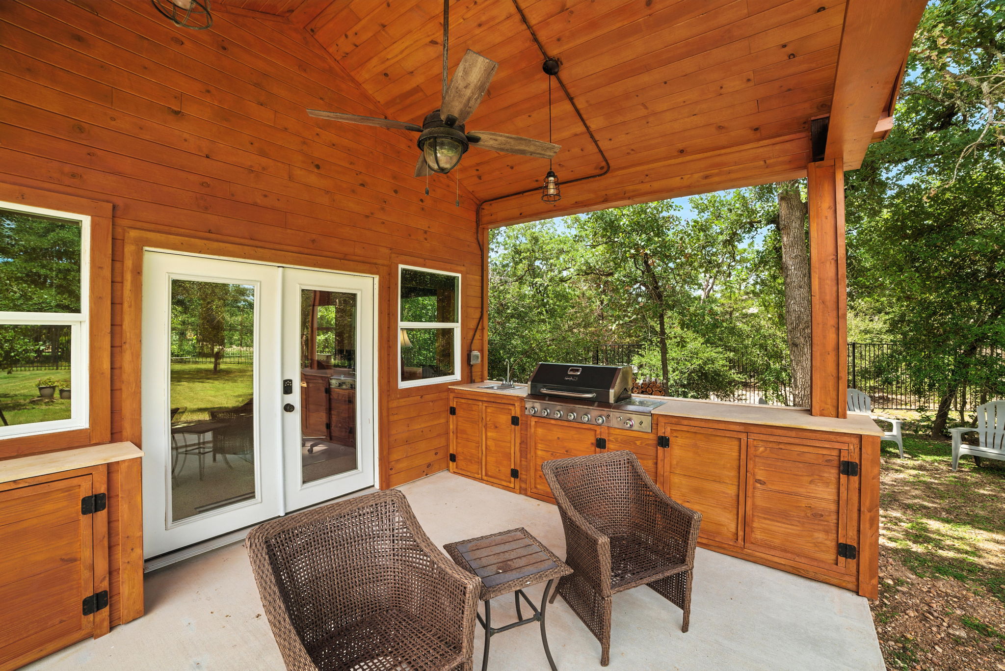 107 Tylee Circle Bastrop, TX 78602 - Photo 35 of 40 a view of a patio with a table chairs and a backyard