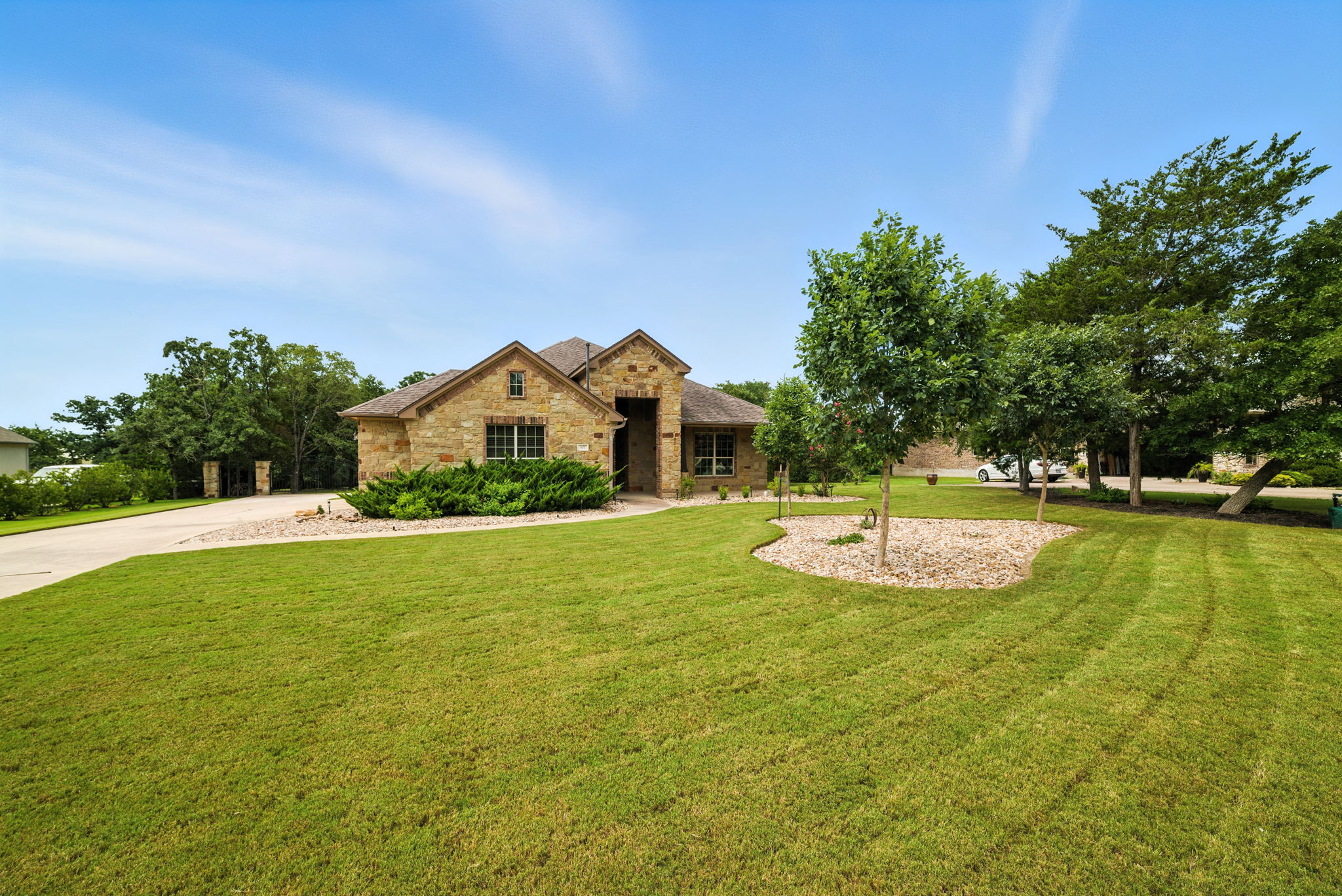 107 Tylee Circle Bastrop, TX 78602 - Photo 4 of 40 View of front facade featuring stone siding, a front lawn, and brick siding