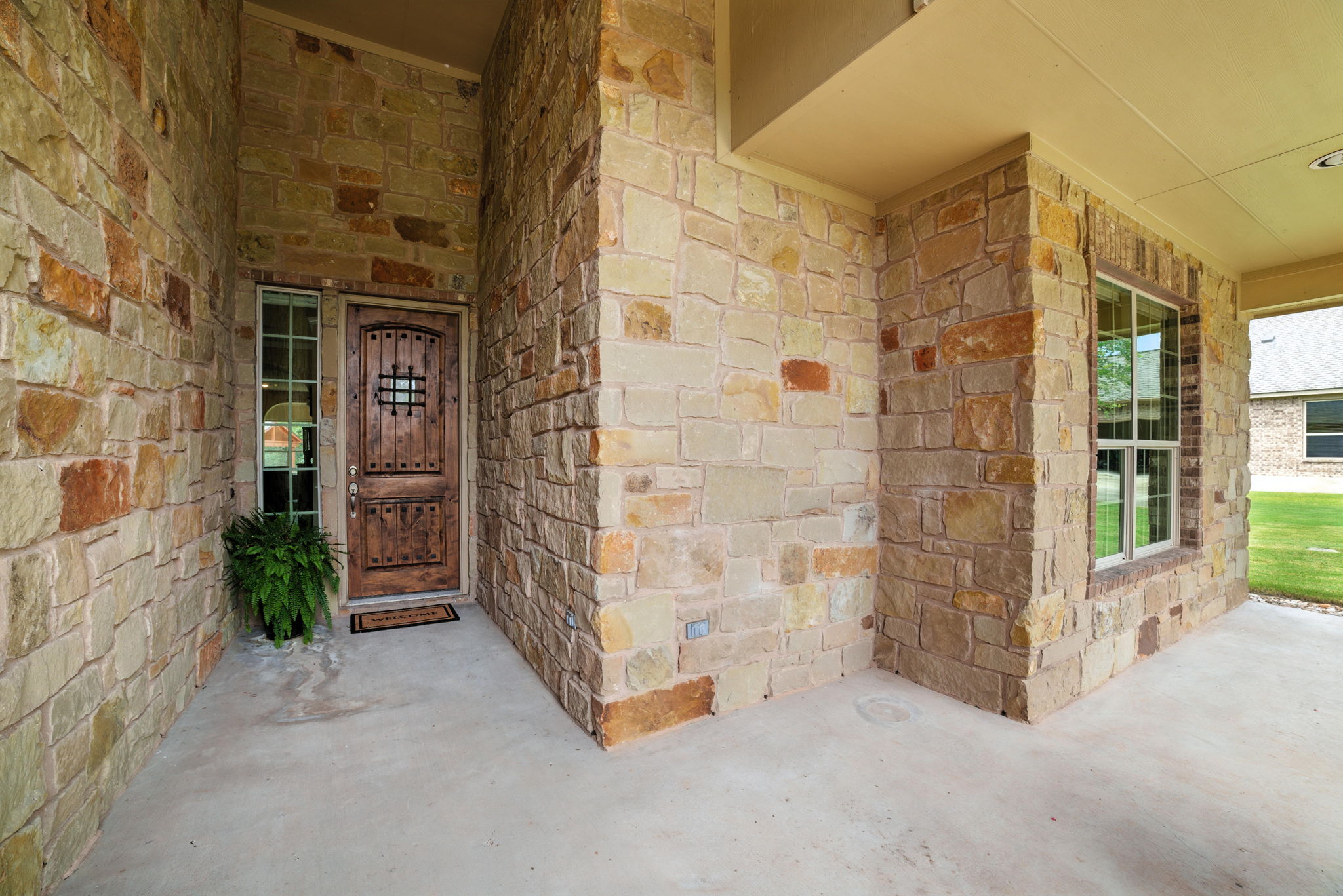 107 Tylee Circle Bastrop, TX 78602 - Photo 6 of 40 Property entrance with stone siding and covered porch