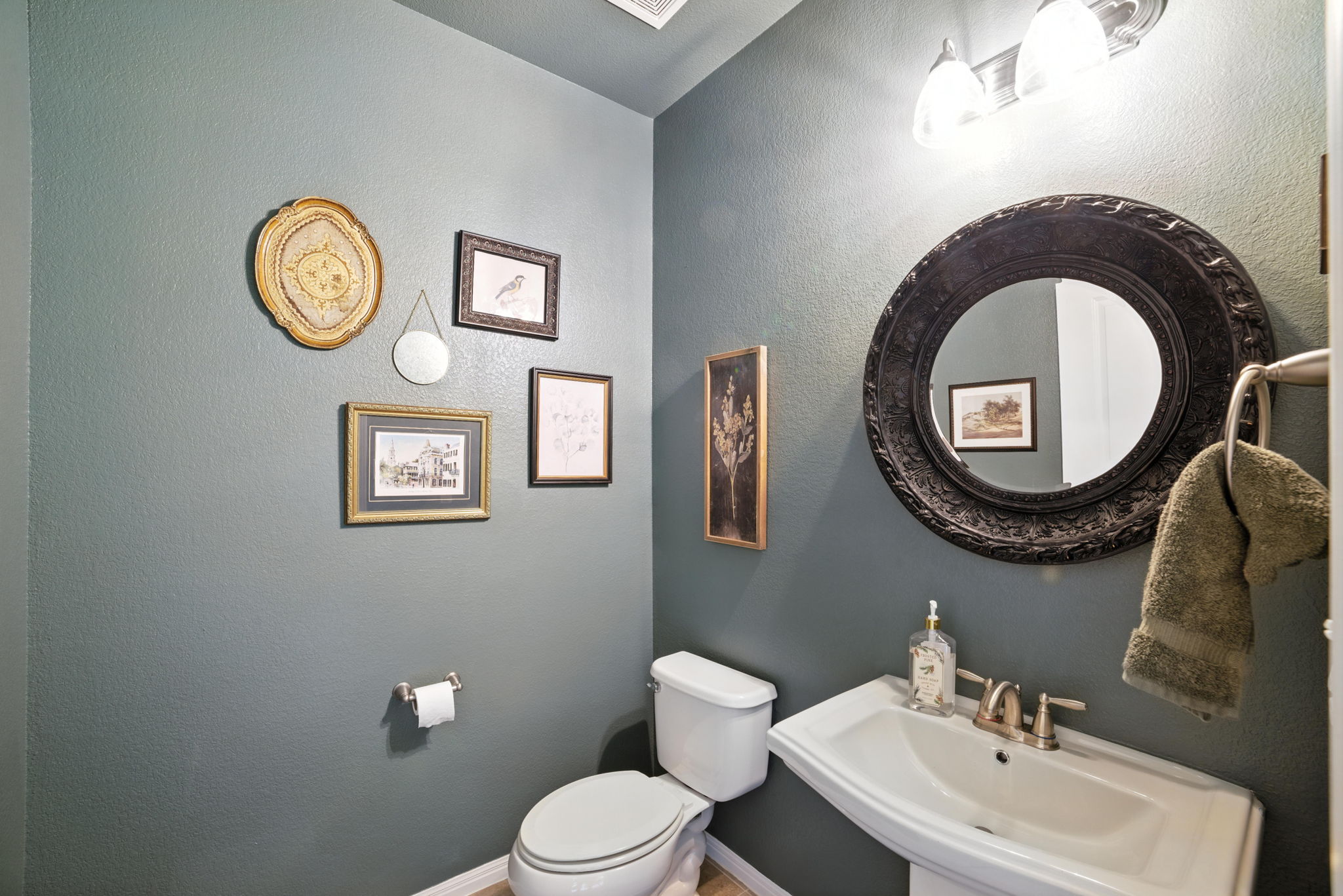 107 Tylee Circle Bastrop, TX 78602 - Photo 10 of 40 a bathroom with a toilet a sink and a mirror