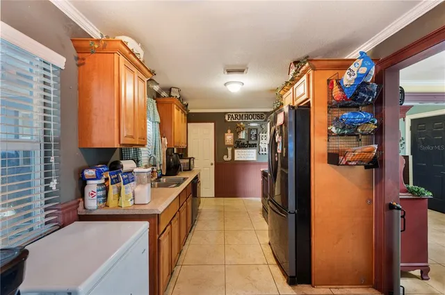 a view of a kitchen with a refrigerator and a stove