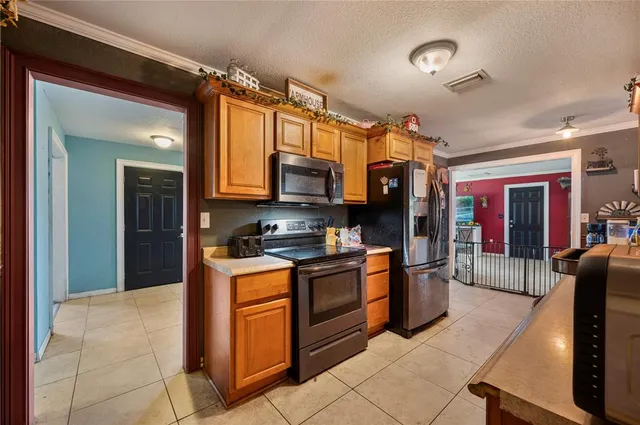 a kitchen with stainless steel appliances granite countertop a refrigerator and a stove