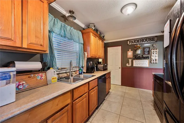 a kitchen with stainless steel appliances granite countertop a refrigerator and a stove