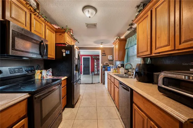a kitchen with stainless steel appliances granite countertop a stove and cabinets