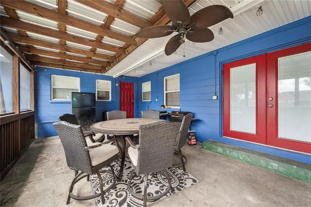a view of a backyard with a small pool and sitting area