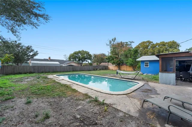 a view of a big yard with large trees and a small yard
