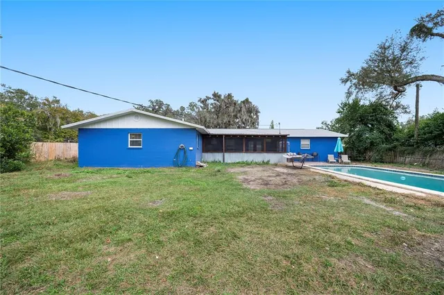 a view of a backyard with a garden and entertaining space