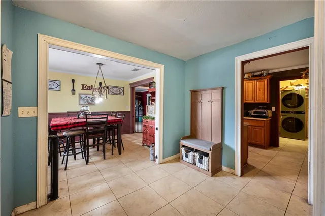 a room with furniture a dining table and a refrigerator