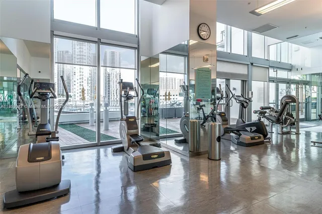 a view of a kitchen with kitchen island a counter top space a sink and appliances