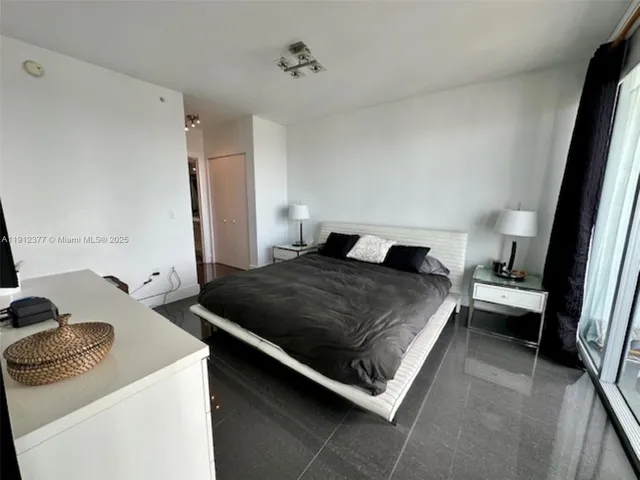 a bedroom with a bed and a couch