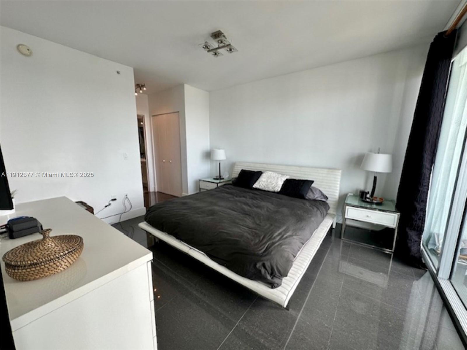 92 Southwest 3rd Street, Unit 4107 Miami, FL 33130 - Photo 9 of 30 a bedroom with a bed and a couch