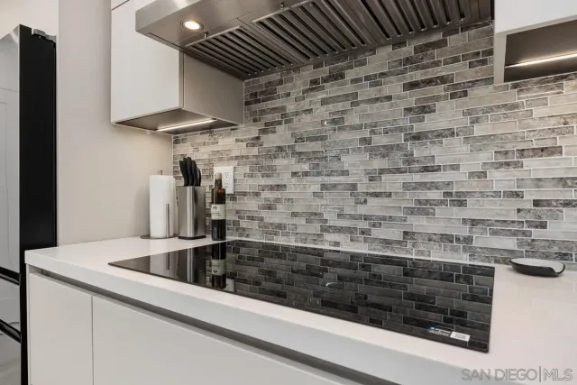 a bed sitting in a spacious bedroom next to a window