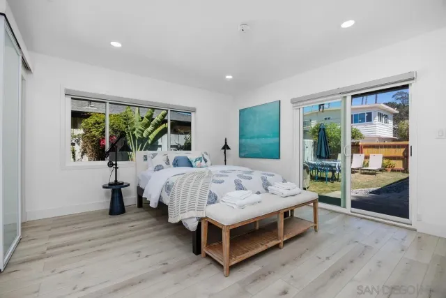 a bedroom with a bed and a mirror