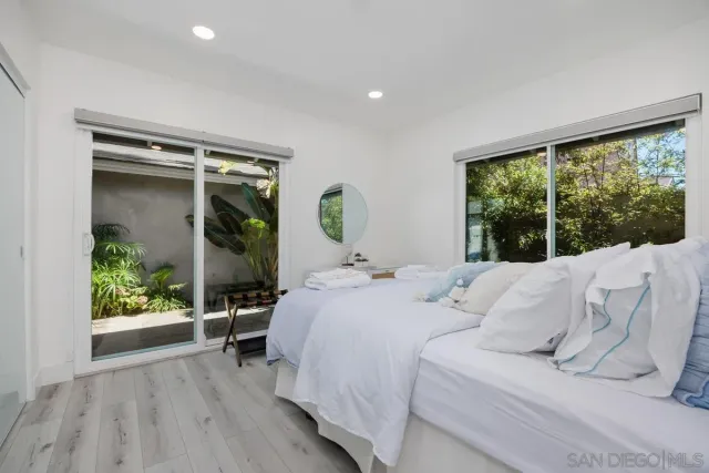 a bedroom with a bed and painting on the wall