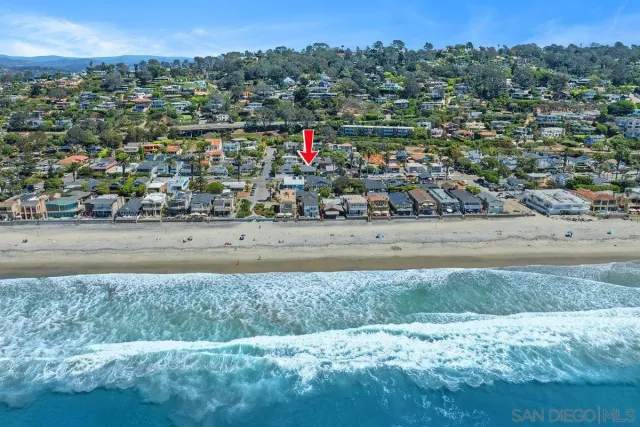 an aerial view of a house with a yard and a fountain