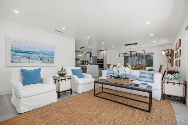 a dining room with furniture a chandelier and wooden floor