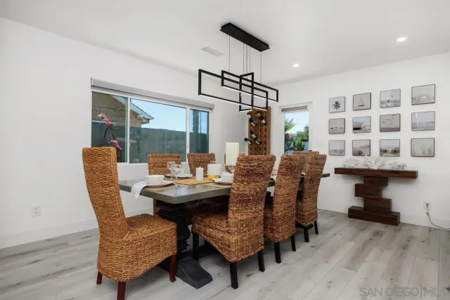 a living room with furniture kitchen view and a flat screen tv