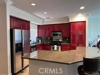 a kitchen with stainless steel appliances granite countertop a sink refrigerator and microwave