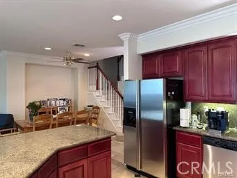 a kitchen with stainless steel appliances granite countertop a refrigerator and a sink
