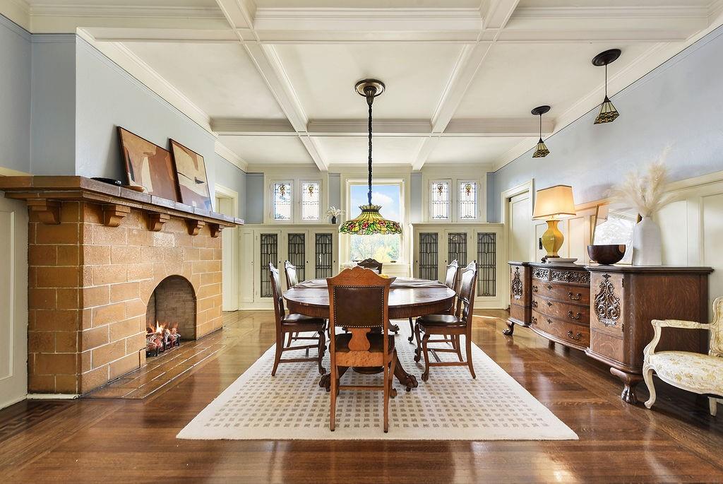 2057 Beechwood Boulevard Pittsburgh, PA 15217 - Photo 19 of 49 a dining room with furniture a fireplace and wooden floor