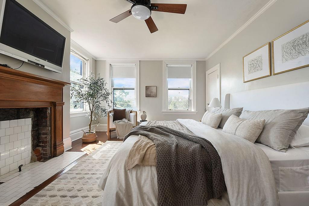 2057 Beechwood Boulevard Pittsburgh, PA 15217 - Photo 31 of 49 a bedroom with a bed a flat screen tv and a fireplace