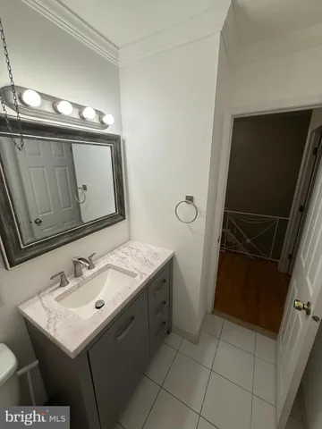 a bathroom with a sink toilet and mirror