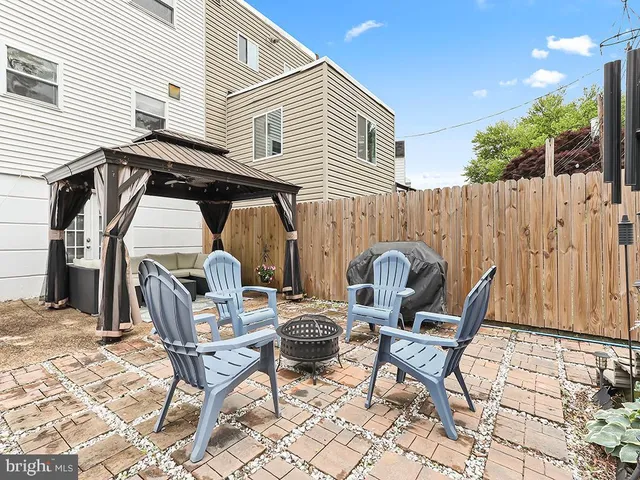 a view of two chairs and a table in the patio