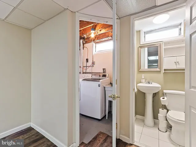 a bathroom with a toilet sink and a mirror