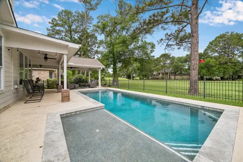 a view of a backyard with a swimming pool