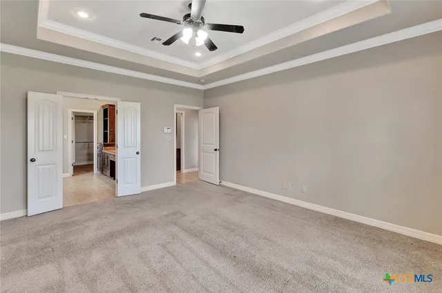 an empty room with fan and entrance