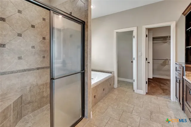 a bathroom with a shower and a glass door
