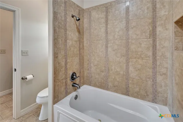 a bathroom with a bathtub and toilet