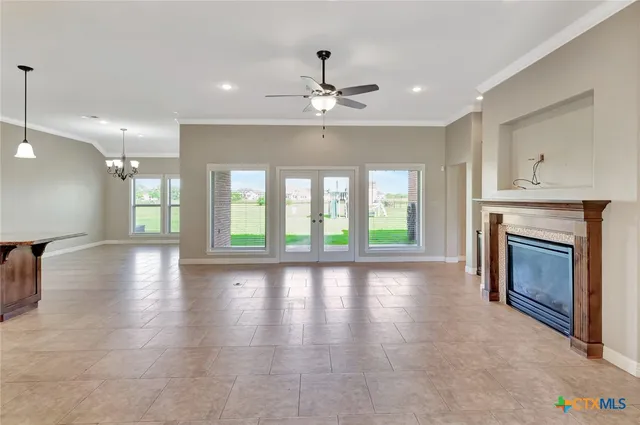 a view of an empty room with a fireplace and a window