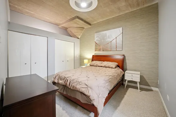 a bedroom with a bed and wall painting