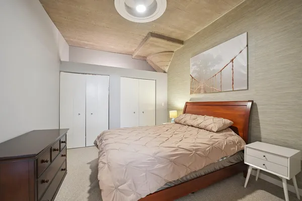 a bedroom with a bed and cabinets