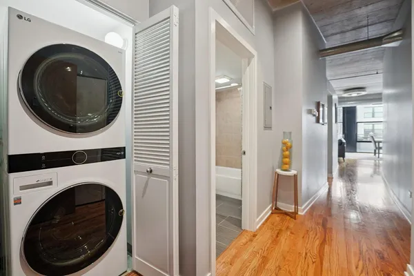 a view of a hallway with washer and dryer