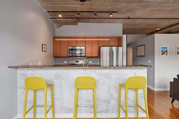 a kitchen with furniture a counter top space and cabinets