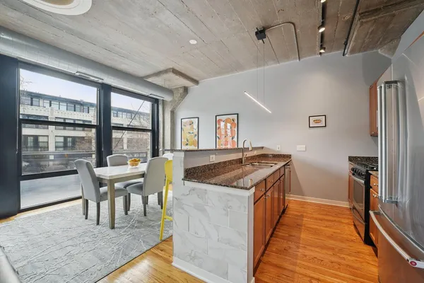 a kitchen with a stove and chairs