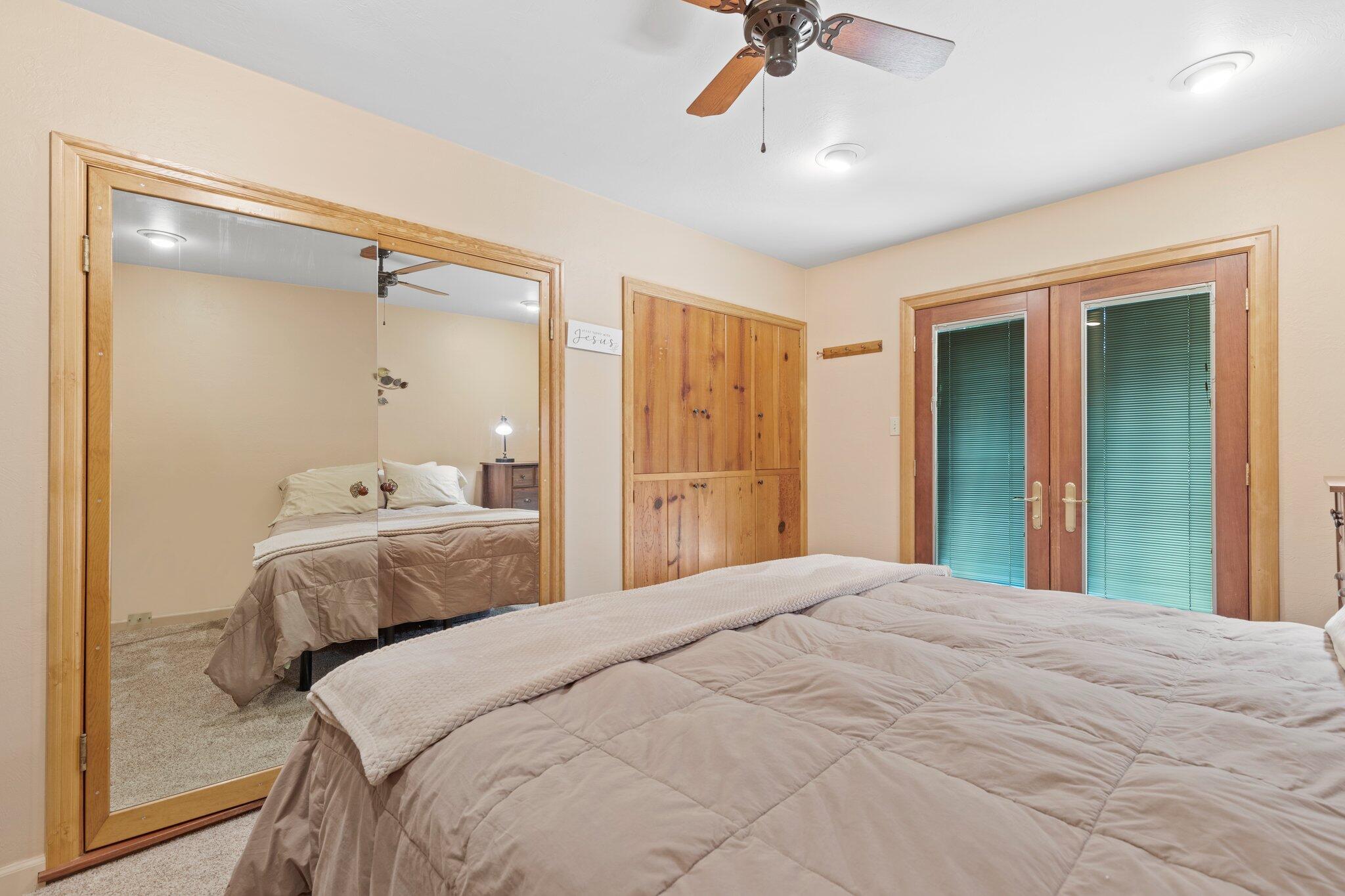 6062 Adams Road Talent, OR 97540 - Photo 17 of 75 a bedroom with a bed and a chandelier